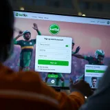 User interface displaying sports betting options and live game updates on mobile device